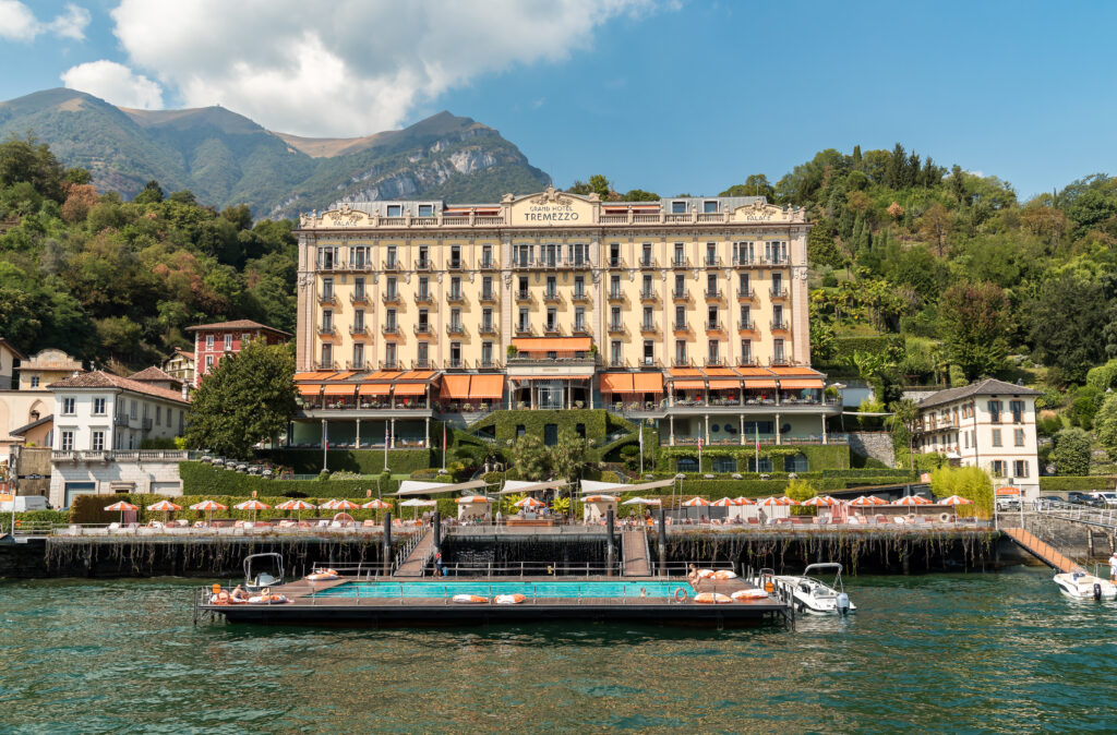 Grand Hotel with terraces and a jetty, situated on a lake and surrounded by green hills and mountains - perfect for destination weddings or unforgettable wedding photography.