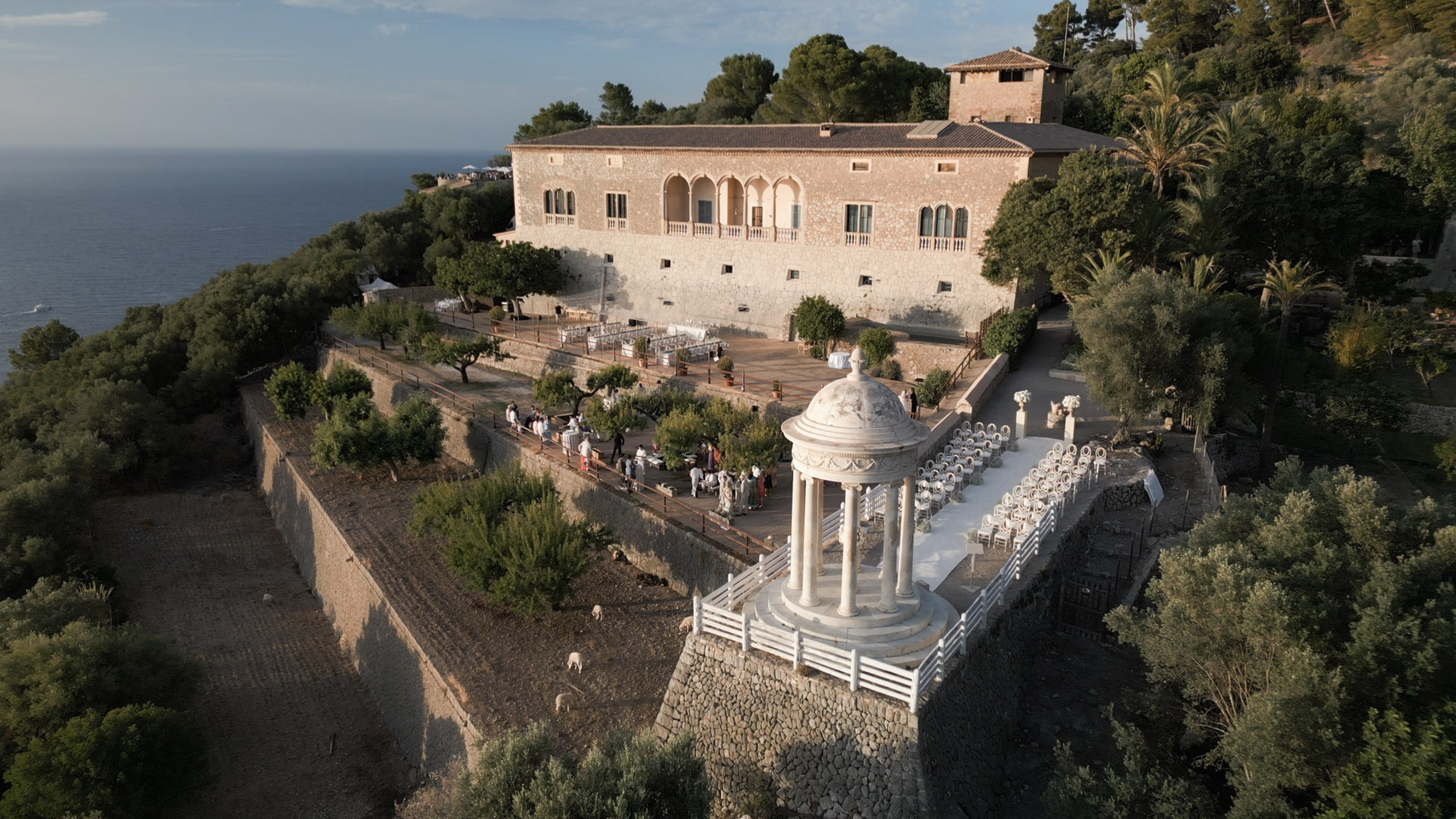 Wedding in Son Marroig: Getting married over the cliffs of Mallorca, with experience, costs and tips 15 Aerial view of a wedding ceremony outdoors at the historic estate Son Marroig by the sea.
