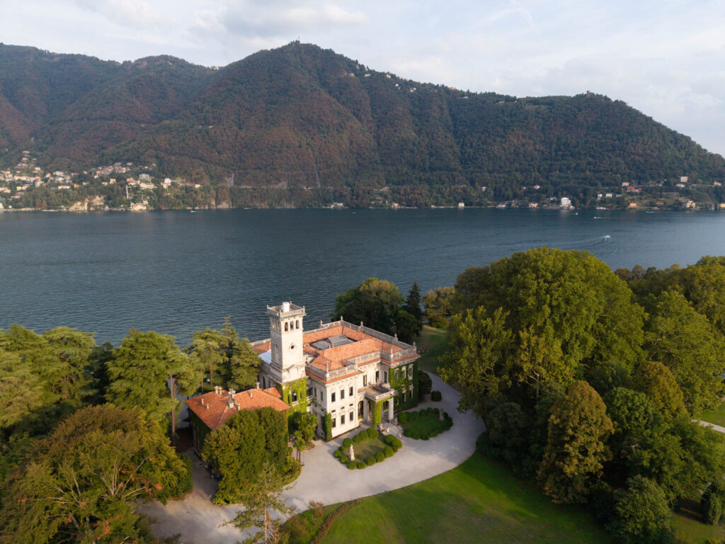 Villa with tower on the lake, nestled between trees and mountains, designed with automatic drafting.